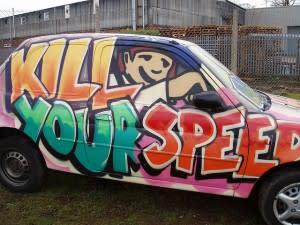 Car fully covered with anti-speeding slogan