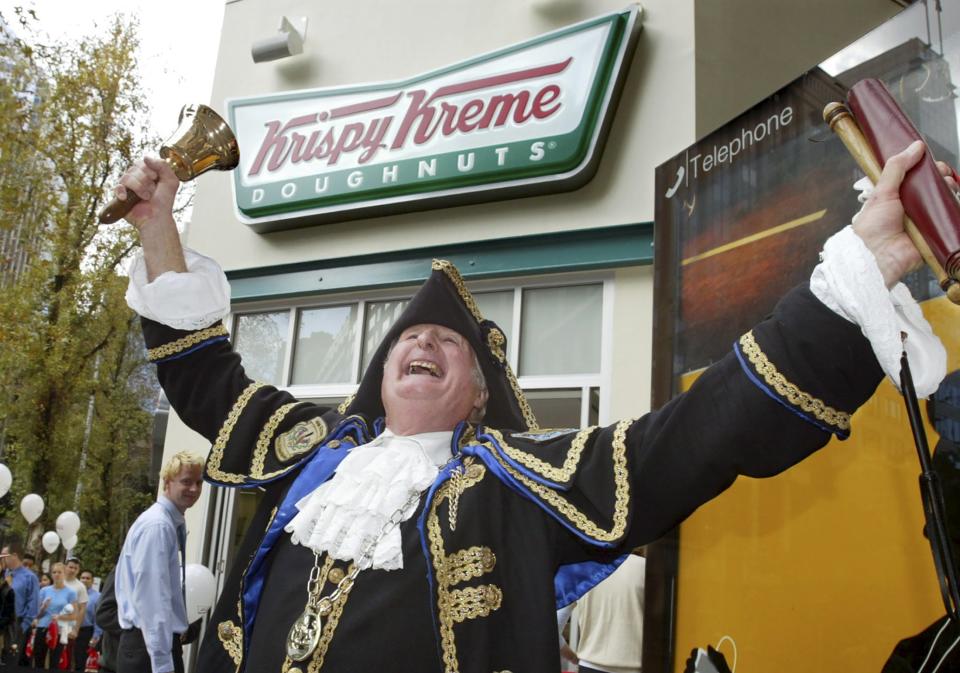 Sydney town Crier Graham Keating heralds the opening of a Krispy Kreme store in Sydney, May 2004. REUTERS