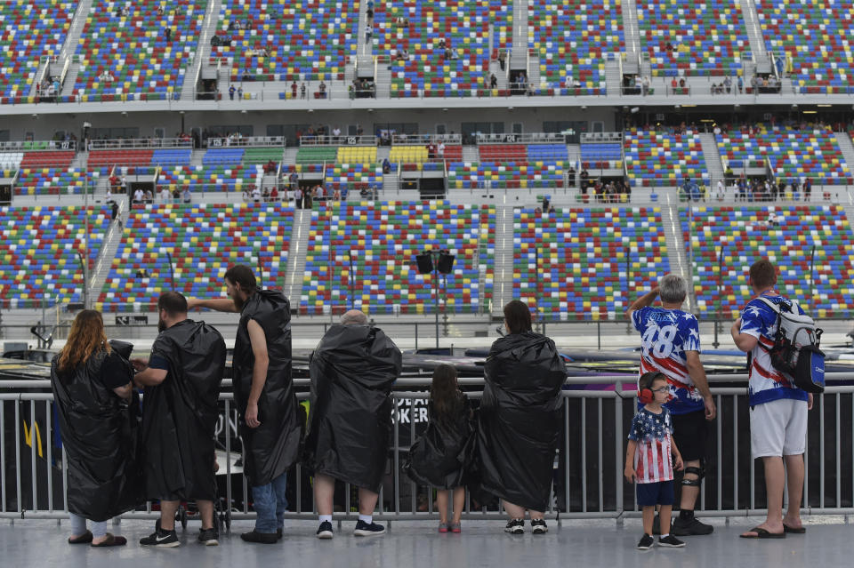 DAYTONA BEACH, FLORIDA - JULY 06: Fans wait out a rain delay near the garage during the Monster Energy NASCAR Cup Series Coke Zero Sugar 400 at Daytona International Speedway on July 06, 2019 in Daytona Beach, Florida. (Photo by Jeff Curry/Getty Images)