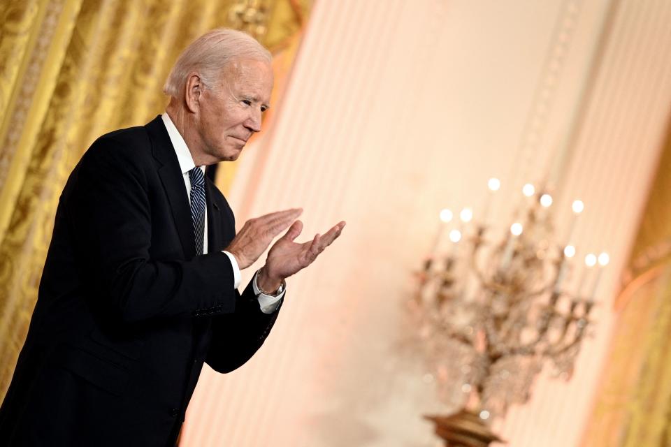 TOPSHOT - US President Joe Biden claps as he hosts a reception to celebrate Diwali in the East Room of the White House in Washington, DC, on October 24, 2022. (Photo by Brendan SMIALOWSKI / AFP) (Photo by BRENDAN SMIALOWSKI/AFP via Getty Images)