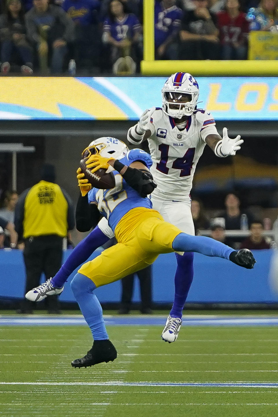 Los Angeles Chargers safety Alohi Gilman (32) intercepts a pass intended for Buffalo Bills wide receiver Stefon Diggs (14) during the second half of an NFL football game Saturday, Dec. 23, 2023, in Inglewood, Calif. (AP Photo/Ryan Sun)