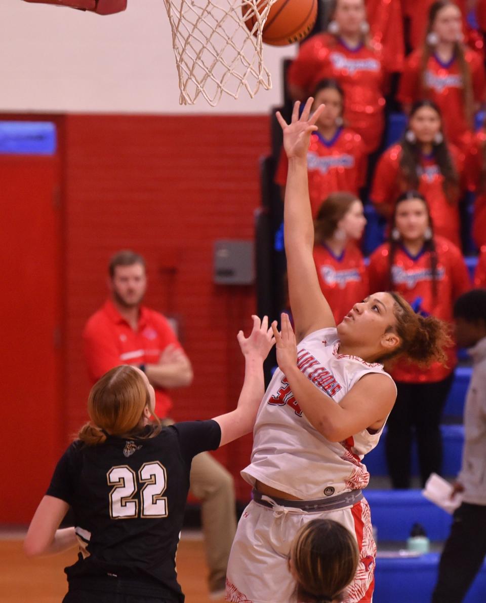 Abilene Cooper's J'Lee Sloan, right, shoots over Lubbock High's Pierce Scheppler in the first half. The Lady Cougars beat Lubbock High 60-53 in the District 4-5A game Tuesday, Jan. 9, 2024, at Cougar Gym.