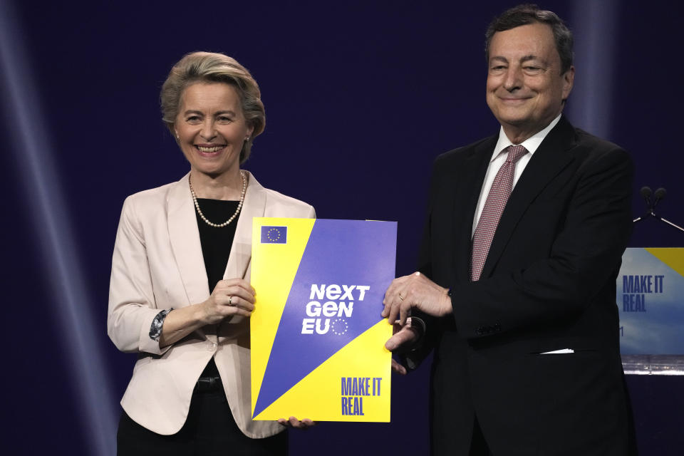 Italian Premier Mario Draghi receives a Next Gen EU plan brochure from European Commission President Ursula von der Leyen, at the Cinecitta' studios in Rome, Tuesday, June 22, 2021. (AP Photo/Andrew Medichini)