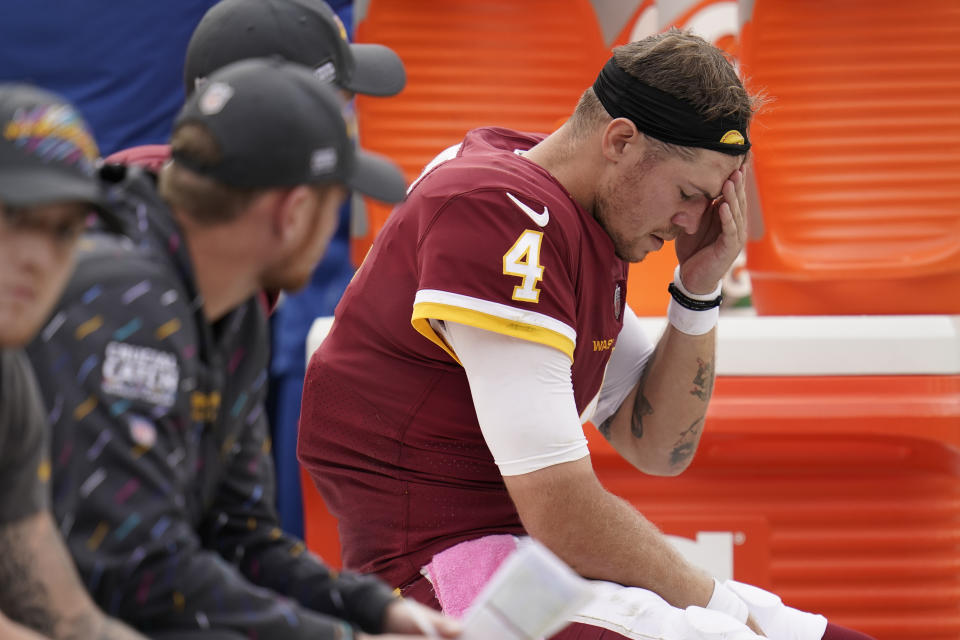 Washington Football Team quarterback Taylor Heinicke sits on the bench in the second half of an NFL football game against the New Orleans Saints, Sunday, Oct. 10, 2021, in Landover, Md. (AP Photo/Julio Cortez)