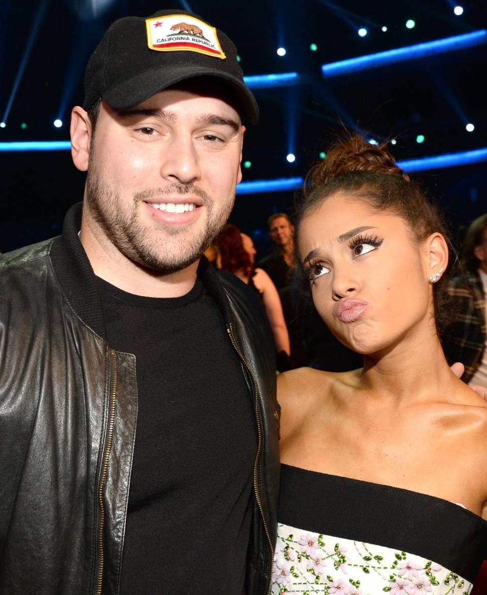 A closeup of Scooter Braun and Ariana Grande who's making a silly pouting face