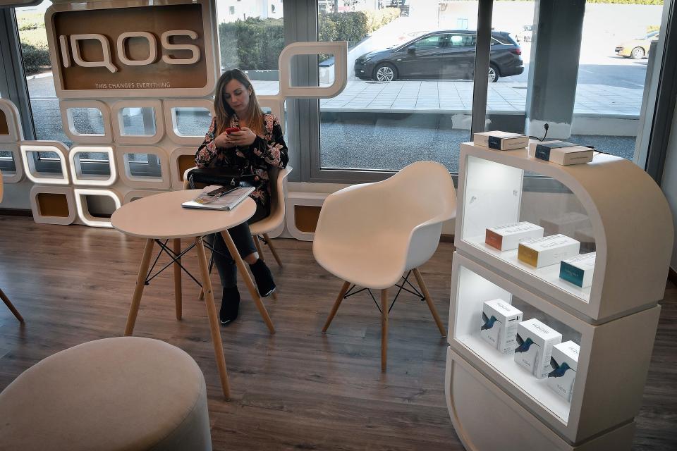 A woman sits in an IQOS lounge at the Papastratos tobbacco company facilities in Aspropyrgos, Greece. Philip Morris International bought Papastratos, Greece's largest tobacco company, in 2003. (Photo: LOUISA GOULIAMAKI via Getty Images)
