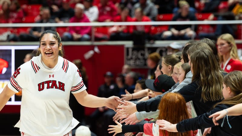 Utah Utes forward Alissa Pili (35) high-fives fans before the women’s college basketball game between the Utah Utes and the Oregon State Beavers at the Jon M. Huntsman Center in Salt Lake City on Friday, Feb. 9, 2024.