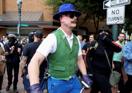 Counter-protesters spray string on a demonstrator after a Proud Boys rally in Portland, Oregon