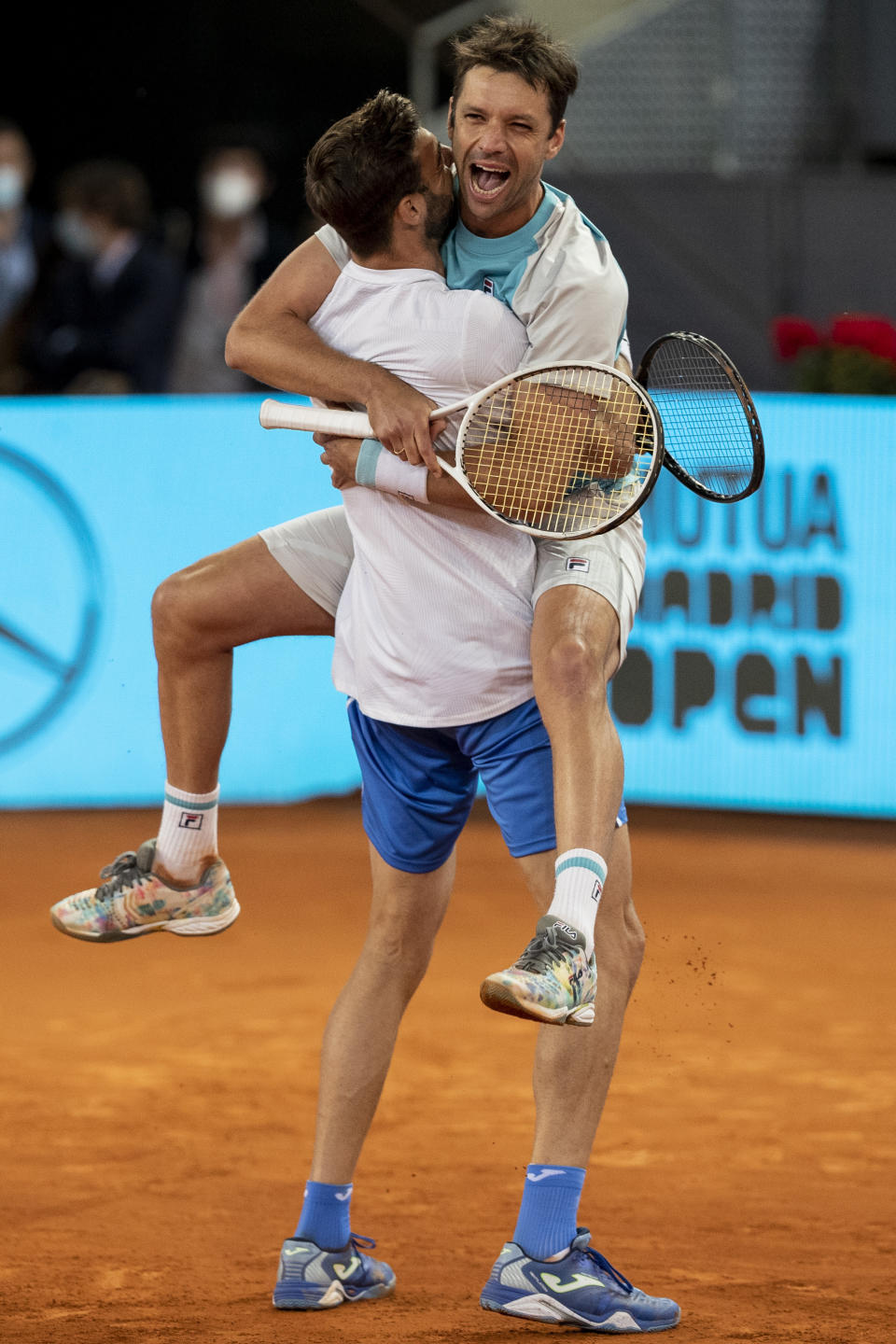 Spain's Marcel Granollers, left, and Horacio Zeballos of Argentina celebrate after winning the men's doubles final match against Croatia's Nikola Mektic and Mate Pavic at the Mutua Madrid Open tennis tournament in Madrid, Spain, Sunday, May 9, 2021. (AP Photo/Bernat Armangue)