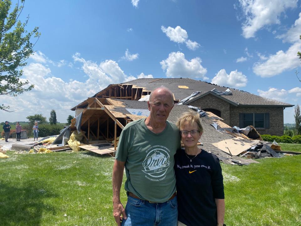 Scott and Betsy Akin stand in front of their home outside of Corning on Wednesday, May 22, 2024, after a powerful tornado ripped through southwest Iowa the day prior.