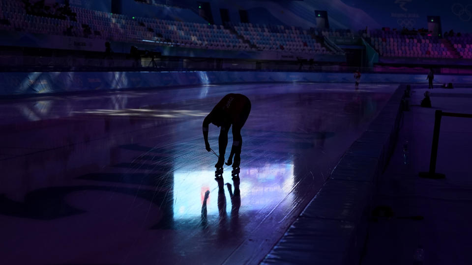 An athlete laces their skate during a speedskating practice ahead of the 2022 Winter Olympics, Wednesday, Feb. 2, 2022, in Beijing. (AP Photo/Ashley Landis)