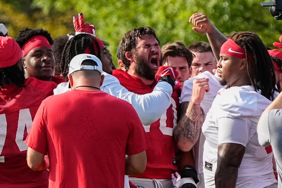 Aug 1, 2024; Columbus, OH, USA; Ohio State Buckeyes offensive lineman Josh Fryar (70) yells as the team huddles during football camp at the Woody Hayes Athletic Complex.