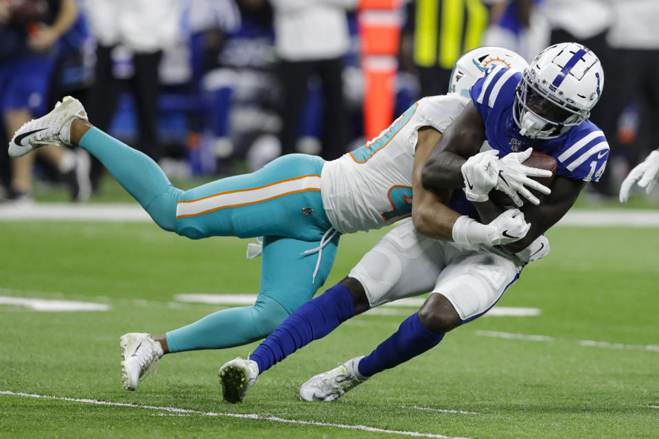 Miami Dolphins defensive back Nik Needham (40) tackles Indianapolis Colts wide receiver Zach Pascal (14) after a catch during the first half of an NFL football game in Indianapolis, Sunday, Nov. 10, 2019. (AP Photo/Darron Cummings)