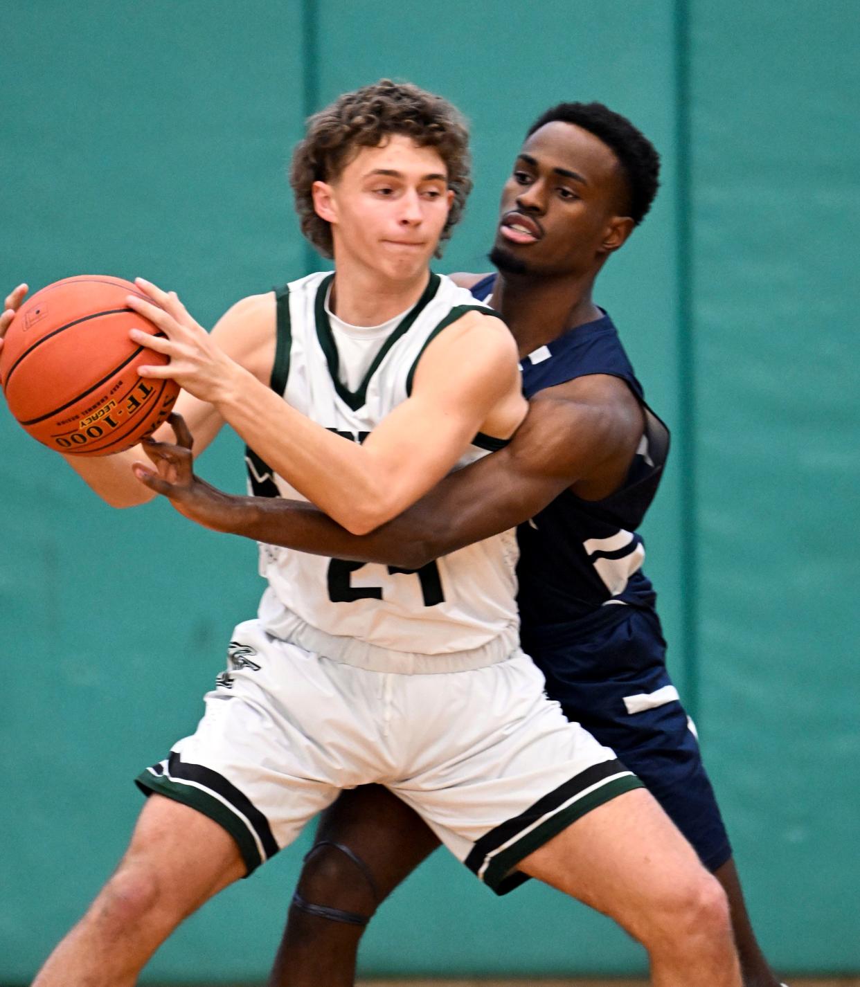 Jayquan Francis of Nantucket attempts to knock the ball loose from Trey McPherson of Dennis-Yarmouth.