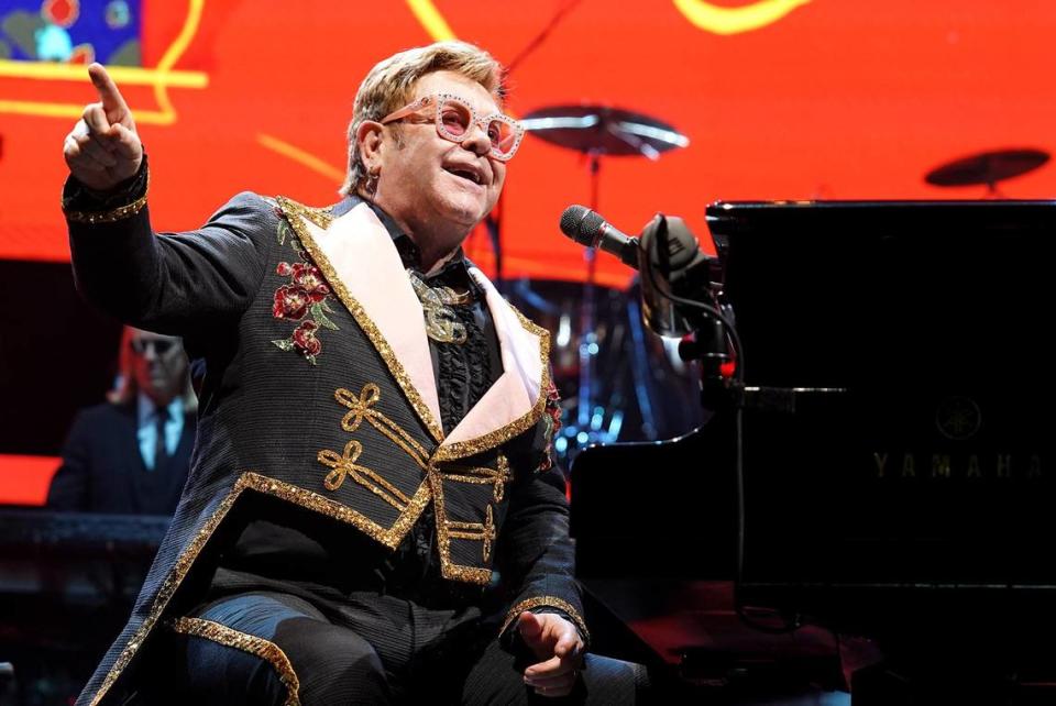 Elton John looks out at the audience and smiles while performing at Spectrum Center in Charlotte in 2019.