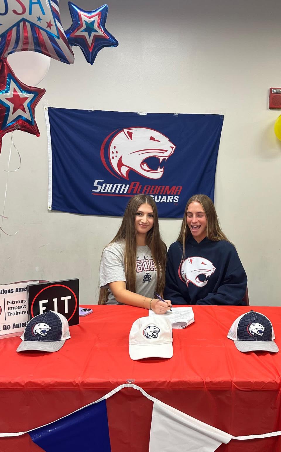 Sitting next to older sister Abby (right), Gulf Breeze's Amelia Jacobs (right) posing for pictures after signing her letter of intent to play soccer collegiately for the University of South Alabama on Wednesday, Nov. 8, 2023.