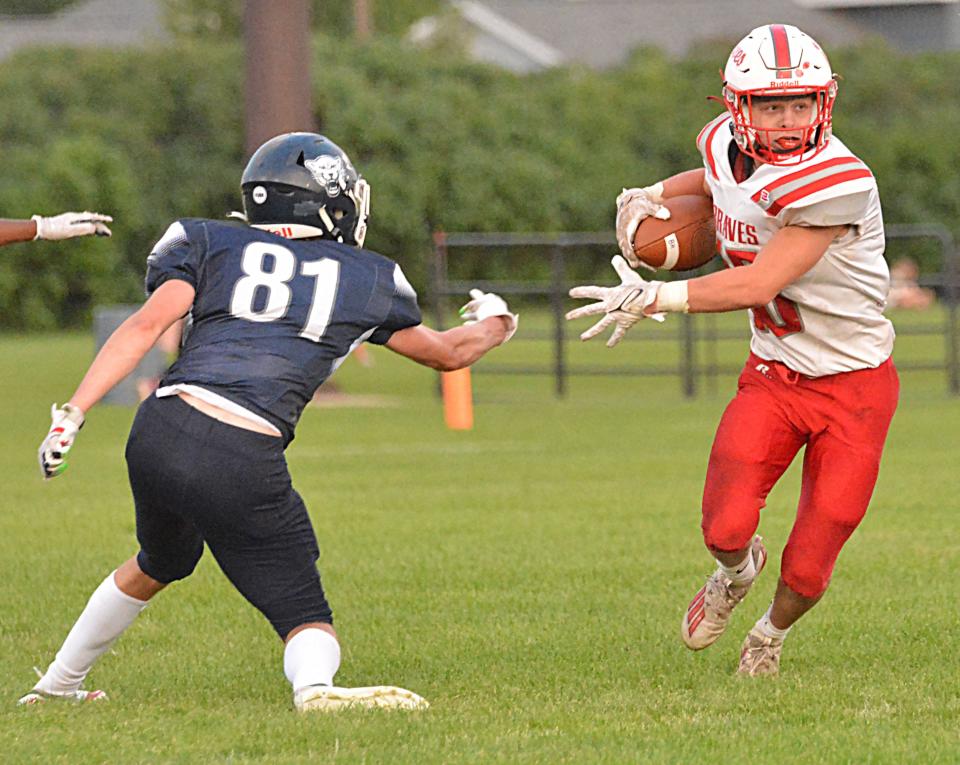 Britton-Hecla's Bryce Hawkinson cuts back against Great Plains Lutheran's Alex Heil during their season-opening high school football game on Friday, Aug. 18, 2023 at Watertown Stadium.