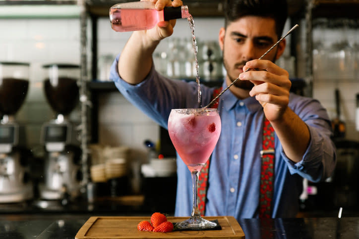 A bartender pouring a drink