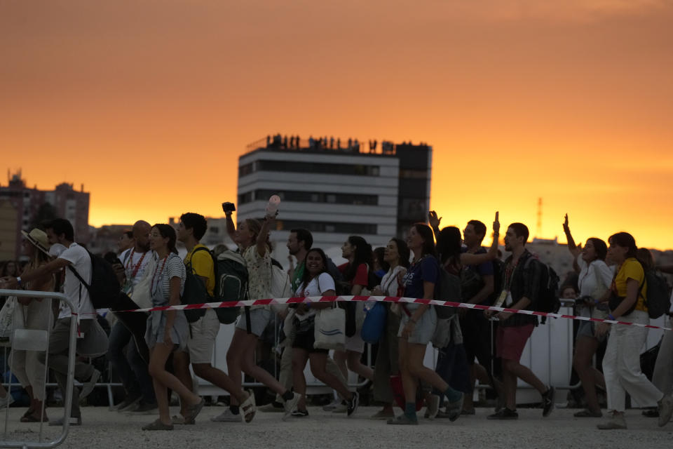 Young people cheer as they arrive at Parque Tejo in Lisbon, Saturday, Aug. 5, 2023, for a vigil with Pope Francis ahead of the 37th World Youth Day. On Sunday morning, the last day of his five-day trip to Portugal, Francis is to preside over a final, outdoor Mass on World Youth Day – when temperatures in Lisbon are expected to top 40 degrees C (104F) – before returning to the Vatican. (AP Photo/Gregorio Borgia)