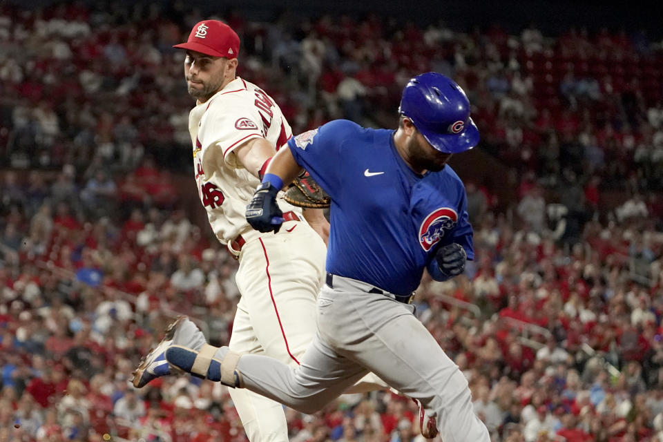Chicago Cubs' Erick Castillo, right, is safe at first for a single as he avoids the tag from St. Louis Cardinals first baseman Paul Goldschmidt during the fifth inning of a baseball game Saturday, Oct. 2, 2021, in St. Louis. (AP Photo/Jeff Roberson)