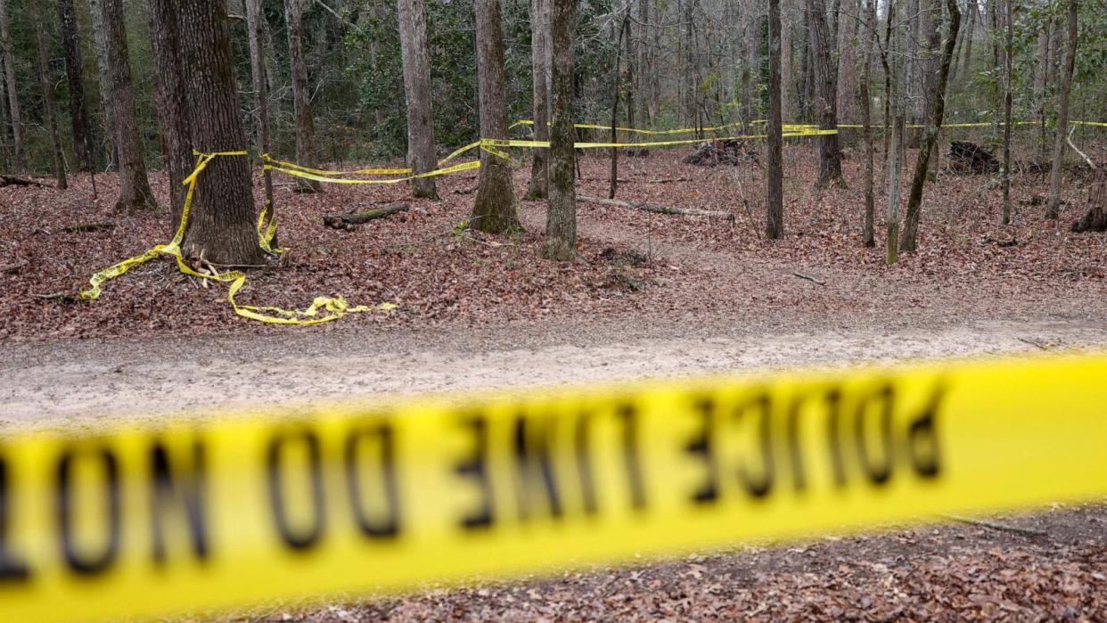 PHOTO: Police tape ropes off the crime scene on a trail behind Lake Herrick in Athens, Georgia, at the University of Georgia, on Feb. 23, 2024. (Jason Getz/The Atlanta Journal-Constitution via ZUMA Press Wire)