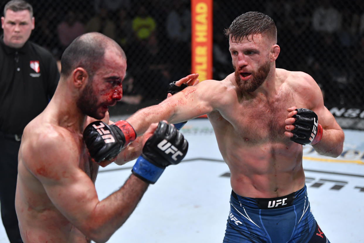 LAS VEGAS, NEVADA - JANUARY 15:  (R-L) Calvin Kattar punches Giga Chikadze of Georgia in their featherweight fight during the UFC Fight Night event at UFC APEX on January 15, 2022 in Las Vegas, Nevada. (Photo by Jeff Bottari/Zuffa LLC via Getty Images)