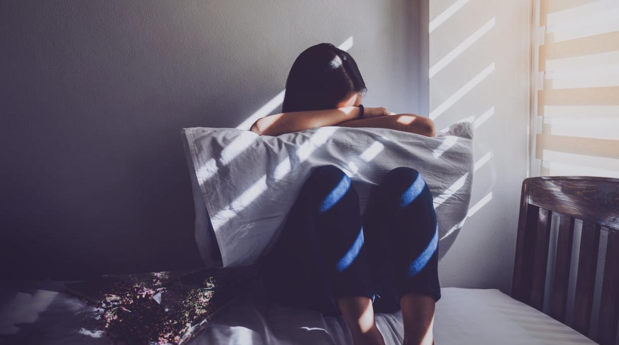 <span class="caption">The pandemic is driving up a litany of social ills.</span> <span class="attribution"><a class="link " href="https://www.gettyimages.com/detail/photo/sad-woman-sitting-on-bed-at-home-royalty-free-image/1155465823?adppopup=true" rel="nofollow noopener" target="_blank" data-ylk="slk:Bundit Binsuk/EyeEm via Getty Images;elm:context_link;itc:0;sec:content-canvas">Bundit Binsuk/EyeEm via Getty Images</a></span>