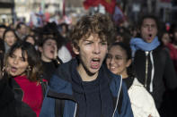 A student shouts during a mass strike in Marseille, southern France, Tuesday, Dec. 10, 2019. French airport employees, teachers and other workers joined nationwide strikes Tuesday as unions cranked up pressure on the government to scrap upcoming changes to the country's national retirement system. (AP Photo/Daniel Cole)