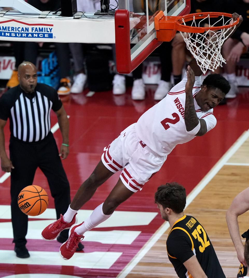 Wisconsin guard AJ Storr hangs on the rim after throwing down a dunk against Iowa during the first half Tuesday night in Madison.



Mark Hoffman/Milwaukee Journal Sentinel