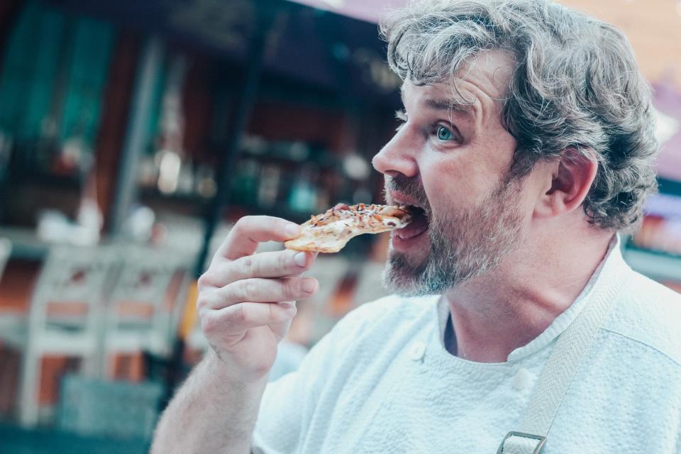 Memphis Chef Kelly English takes a bite of Flammenkuchen. English will be hosting a month-long Oktoberfest pop-up at his Midtown restaurant The Second Line.