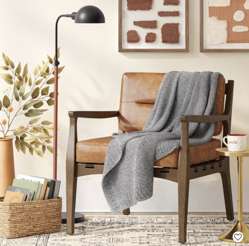 gray throw on a chair in a room