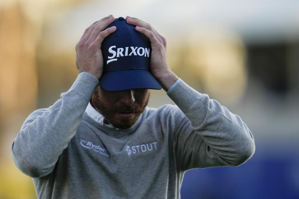 Sam Ryder adjusts his hat after finishing on the 18th hole of the South Course at Torrey Pines during the third round of the Farmers Insurance Open golf tournament, Friday, Jan. 27, 2023, in San Diego. (AP Photo/Gregory Bull)