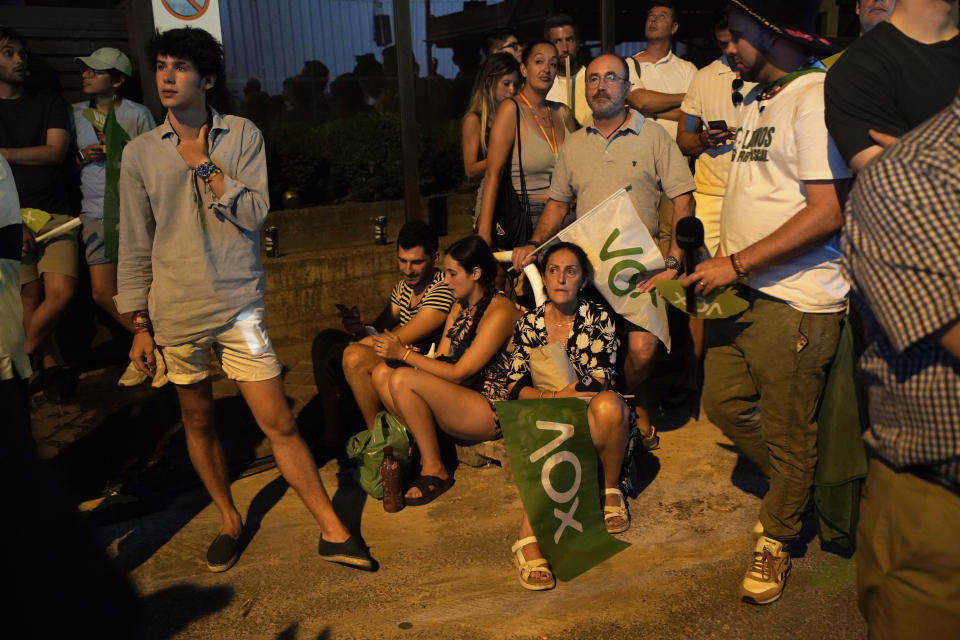 Supporters of far-right Vox party outside the party headquarters in Madrid, wait for the results of Spain's general election, Sunday, July 23, 2023. Polls have closed in Spain's national election as the country's left-wing government faces a risk of being ousted by conservatives and the far-right. (AP Photo/Andrea Comas)