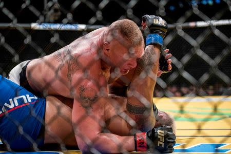 Jul 9, 2016; Las Vegas, NV, USA; Mark Hunt (blue gloves) fights Brock Lesnar (red gloves) during UFC 200 at T-Mobile Arena. Joshua Dahl-USA TODAY Sports