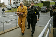 Former Penn State University assistant football coach Jerry Sandusky, left, arrives at the Centre County Courthouse for resentencing on his conviction of 45 counts of child sexual abuse Friday, Nov. 22, 2019, in Bellefonte, Pa. Sandusky was convicted in 2012 and sentenced to 30 to 60 years. (AP Photo/Gene J. Puskar)