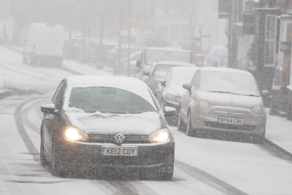 A car driving through a snow flurry in Lenham, Kent. Sleet and snow showers have been forecast for parts of the country on Monday (PA)