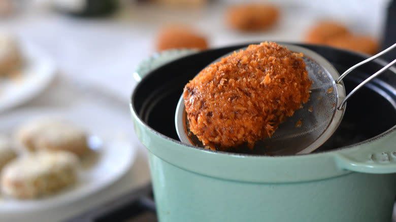croquettes frying in dutch oven