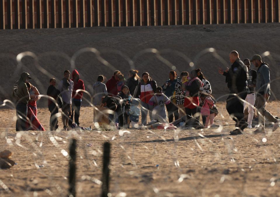 Migrants wait on the banks of the Rio Grande to be processed by the Border Patrol in Texas after crossing from Ciudad Juárez, Mexico, on May 11, 2023. / Credit: HERIKA MARTINEZ/AFP via Getty Images