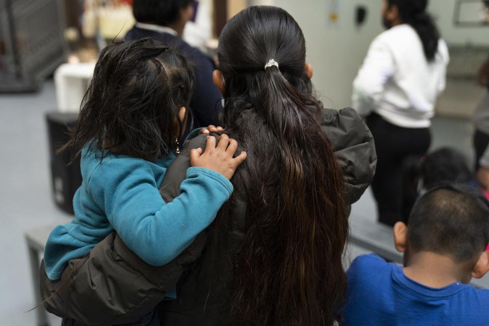 Migrants listen to Father Jose Machado, a visiting priest from Wichita, during a Mass at Kino Border Initiative on Dec. 21, 2022, in Nogales, Sonora, Mexico. Title 42 was scheduled to end on Dec. 21, but was granted a stay by the U.S. Supreme Court.