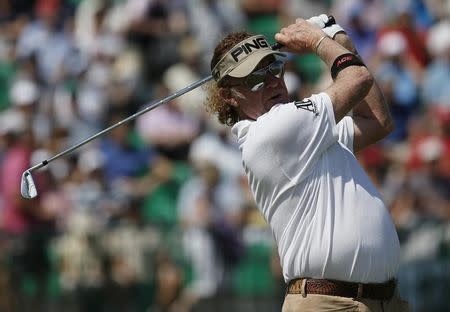 Miguel Angel Jimenez of Spain watches his tee shot on the fourth hole during the first round of the British Open Championship at the Royal Liverpool Golf Club in Hoylake, northern England July 17, 2014. REUTERS/Stefan Wermuth