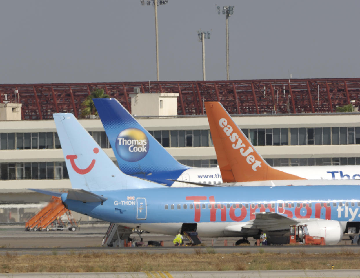 tail-fins of Thomsonfly.com Boeing 737-300, easyJet 737-800 and Thomas Cook 757-200 parked at the terminal at Palma International. (Photo by: aviation-images.com/Universal Images Group via Getty Images)