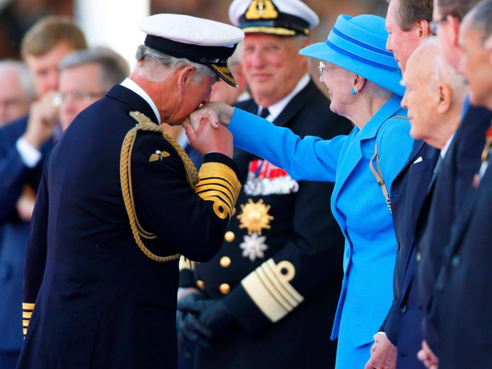 King Charles kisses Queen Margrethe's hand