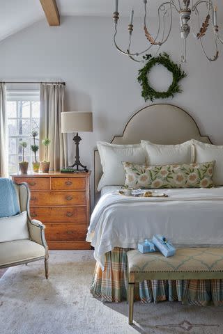 <p>ALISON GOOTEE</p> A trio of myrtle topiaries in varying heights keeps the nightstand feeling festive all year long.