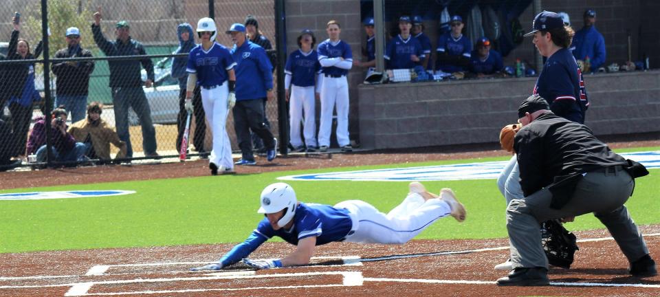 Keatan Allen dives for home plate after racing from third base on a wild pitch in the bottom of the seventh inning to score the winning run in a 3-2 decision over Lubbock Trinity JV on Saturday. It was the first game played at the school's Hudson Wade Memorial Field.