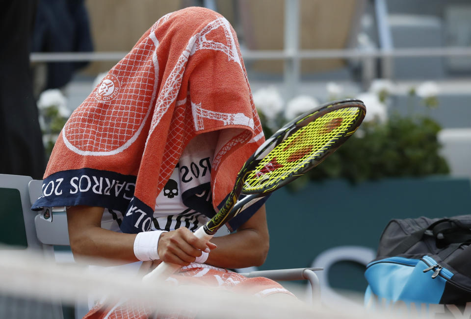 Vitalia Diatchenko of Russia covers herself with a towel after her loss against Serena Williams of the U.S. during their first round match of the French Open tennis tournament at the Roland Garros stadium in Paris, Monday, May 27, 2019. (AP Photo/Pavel Golovkin)