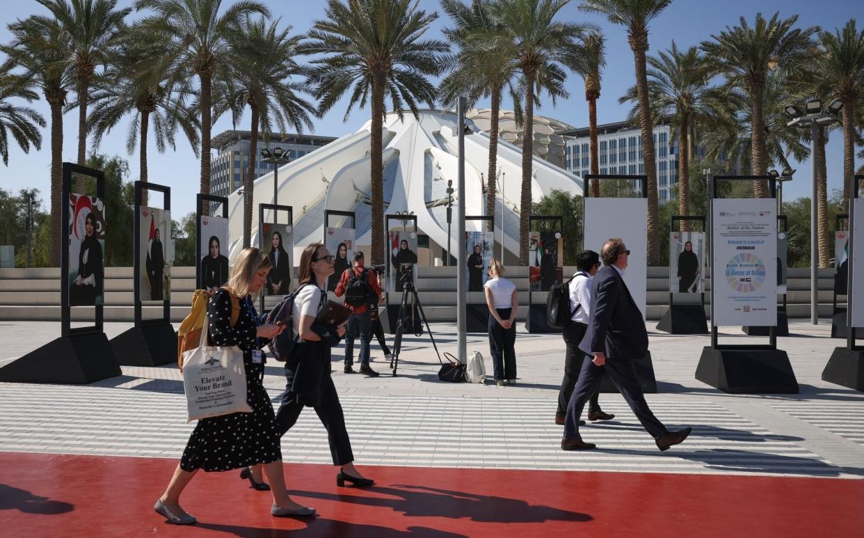 Attendees walk through the Green Zone on day two of the COP28 climate conference at Expo City in Dubai