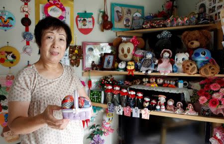 Keiko Abe, a tsunami survivor, poses inside a prefabricated room at the Kaisei temporary housing complex, where evacuees from the coastal area live in Ishinomaki, Miyagi prefecture September 11, 2014. REUTERS/Antoni Slodkowski