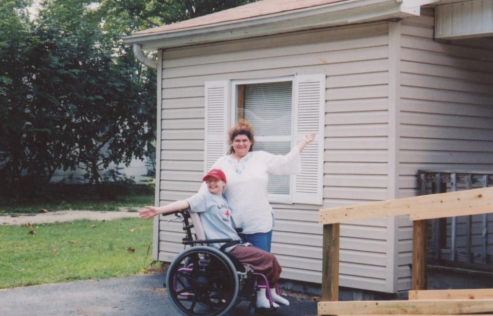 Gypsy Rose Blanchard and her mother, Dee Dee Blanchard, pose in front of the house built from them in Missouri through Habitat for Humanity - one of several scams pulled off by Dee Dee Blanchard as she presented her daughter as dying from leukemia and other ailments.