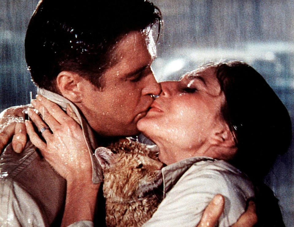 George Peppard and Audrey Hepburn kiss passionately in the rain in a scene from "Breakfast at Tiffany's"