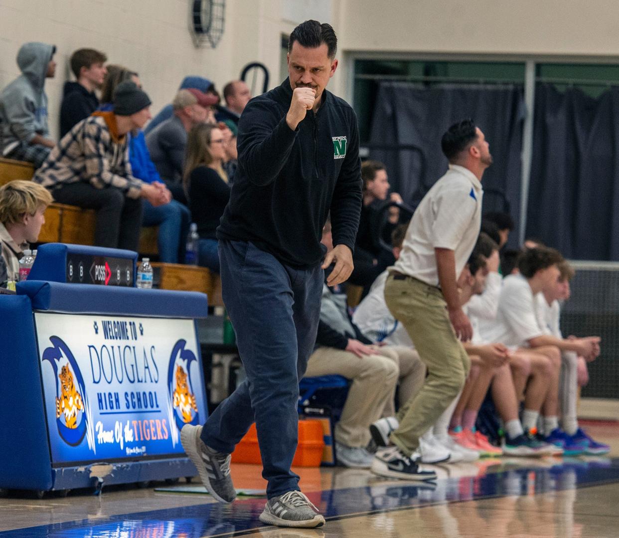 Nipmuc High School Head Boys Basketball Coach Jason Gosselin, left, reacts to a play. At right is his brother, Douglas Head Coach Chad Gosselin, during the game at Douglas High School, where they both also went to school, Jan. 3, 2024.